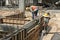 Two Construction Workers Installing Ground Beam Formwork