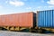 Two containers on a freight train parked in a rail terminal