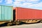 Two containers on a freight train parked in a rail terminal