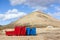 Two containers in red and blue in volcanic landscape