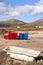 Two containers in red and blue in volcanic landscape