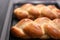 Two cooked challah sweet bread on a baking tray