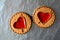 Two cookies hearts foil background