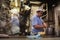 Two cooks preparing food at street stall by night. Shop serving delicious tempura and noodles soup. Omoide Yokocho, Shinjuku,