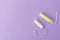 Two cotton tampons with light green applicator and without applicator on a violet background. Hygienic types of tampons.