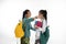 Two couple student meet friend carrying bag and books in traditional clothes