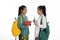 Two couple student talk together carrying bag and books in traditional clothes