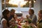 Two couples eating dinner on a roof terrace, close up