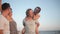 Two Couples Laughing near the Sea During Summer Time. Outdoors Portrait of Happy Young Group of Friends Enjoying Beach