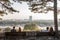 Two couples of lovers sitting on benches observing New Belgrade Novi Beograd at sunset, with the Usce tower in front