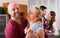 Two couples smiling and moving in slow dance