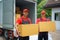 Two Couriers Handing Over Packages to Customers at Home