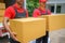 Two Couriers Handing Over Packages to Customers at Home