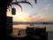 Two Cozy Chairs at Waterfront Cafe against the Afterglow of Sunset Sky