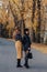 Two cozy smiling young girls walk at autumn park road