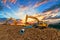 Two crawler excavators digging water pipes at construction site.