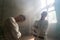 Two crazy men in straitjackets are in an abandoned clinic