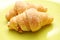 Two crescent roll on green plate