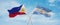 two crossed flags Argentina and Philippines waving in wind at cloudy sky. Concept of relationship, dialog, travelling between two
