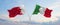 two crossed flags Bahrain and Italy waving in wind at cloudy sky. Concept of relationship, dialog, travelling between two