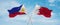 two crossed flags Bahrain and Philippines waving in wind at cloudy sky. Concept of relationship, dialog, travelling between two