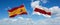 two crossed flags Belarus and spain waving in wind at cloudy sky. Concept of relationship, dialog, travelling between two
