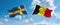 two crossed flags Belgium and Sweden waving in wind at cloudy sky. Concept of relationship, dialog, travelling between two