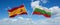 two crossed flags Bulgaria and spain waving in wind at cloudy sky. Concept of relationship, dialog, travelling between two