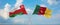 two crossed flags Cameroon and Oman waving in wind at cloudy sky. Concept of relationship, dialog, travelling between two