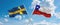 two crossed flags Chile and Sweden waving in wind at cloudy sky. Concept of relationship, dialog, travelling between two countries