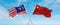 two crossed flags china and Malaysia waving in wind at cloudy sky. Concept of relationship, dialog, travelling between two