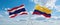 two crossed flags Colombia and Thailand waving in wind at cloudy sky. Concept of relationship, dialog, travelling between two