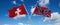 two crossed flags confederate battle or Dixie flag and Switzerland waving in wind at cloudy sky. Concept of relationship, dialog,