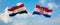 two crossed flags Croatia and Egypt waving in wind at cloudy sky. Concept of relationship, dialog, travelling between two