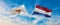 two crossed flags Cyprus and Netherland waving in wind at cloudy sky. Concept of relationship, dialog, travelling between two