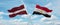 two crossed flags Egypt and Latvia waving in wind at cloudy sky. Concept of relationship, dialog, travelling between two