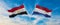 two crossed flags Egypt and Netherland waving in wind at cloudy sky. Concept of relationship, dialog, travelling between two