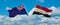 two crossed flags Egypt and New Zealand waving in wind at cloudy sky. Concept of relationship, dialog, travelling between two