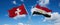 two crossed flags Egypt and Switzerland waving in wind at cloudy sky. Concept of relationship, dialog, travelling between two