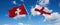 two crossed flags England and Switzerland waving in wind at cloudy sky. Concept of relationship, dialog, travelling between two