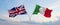 two crossed flags Great Britain and Italy waving in wind at cloudy sky. Concept of relationship, dialog, travelling between two