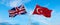 two crossed flags Great Britain and Turkey waving in wind at cloudy sky. Concept of relationship, dialog, travelling between two