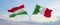 two crossed flags Hungary and Italy waving in wind at cloudy sky. Concept of relationship, dialog, travelling between two
