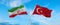two crossed flags Iran and Turkey waving in wind at cloudy sky. Concept of relationship, dialog, travelling between two countries