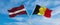 two crossed flags latvia and Belgium waving in wind at cloudy sky. Concept of relationship, dialog, travelling between two