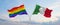 two crossed flags LGBT Pride and Italy waving in wind at cloudy sky. Concept of relationship, dialog, travelling between two