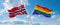two crossed flags LGBT Pride and Norway waving in wind at cloudy sky. Concept of relationship, dialog, travelling between two