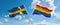 two crossed flags LGBT Pride and Sweden waving in wind at cloudy sky. Concept of relationship, dialog, travelling between two