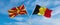 two crossed flags Macedonia and Belgium waving in wind at cloudy sky. Concept of relationship, dialog, travelling between two