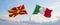 two crossed flags Macedonia and Italy waving in wind at cloudy sky. Concept of relationship, dialog, travelling between two